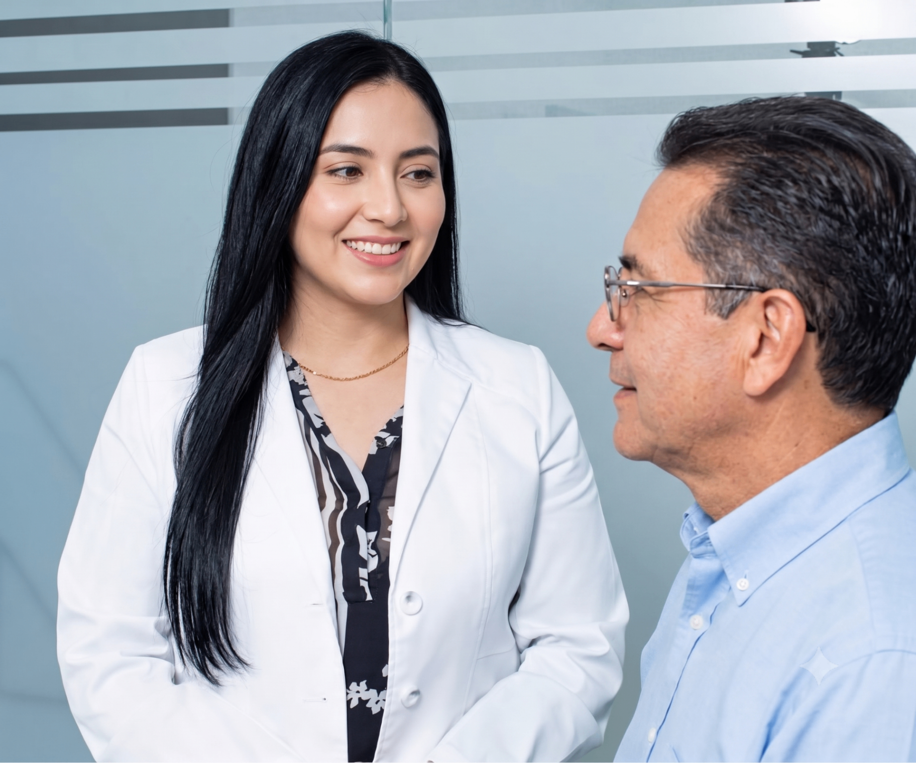 Bariatric surgeon in a white coat consulting with a patient at a Tijuana hospital